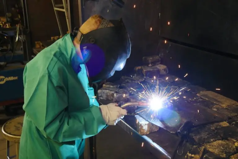 a youth weld metal at a workbench