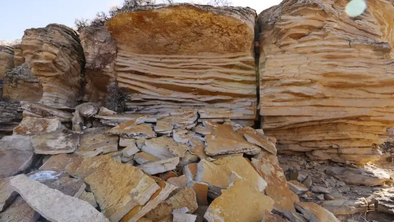 close up showing clear sedimentary rock layers with a pile of broken rock that has eroded below