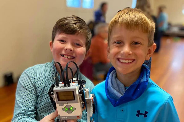 Two boys with a robot
