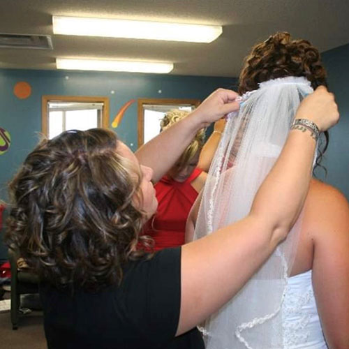 Heather attaching veil to bride